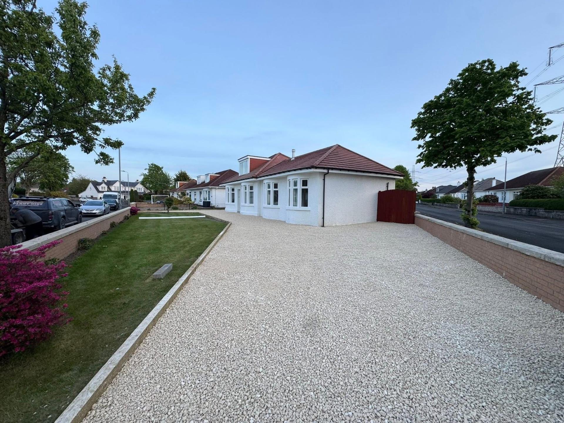 Gravel driveway with timber sleeper edging at Glasgow home