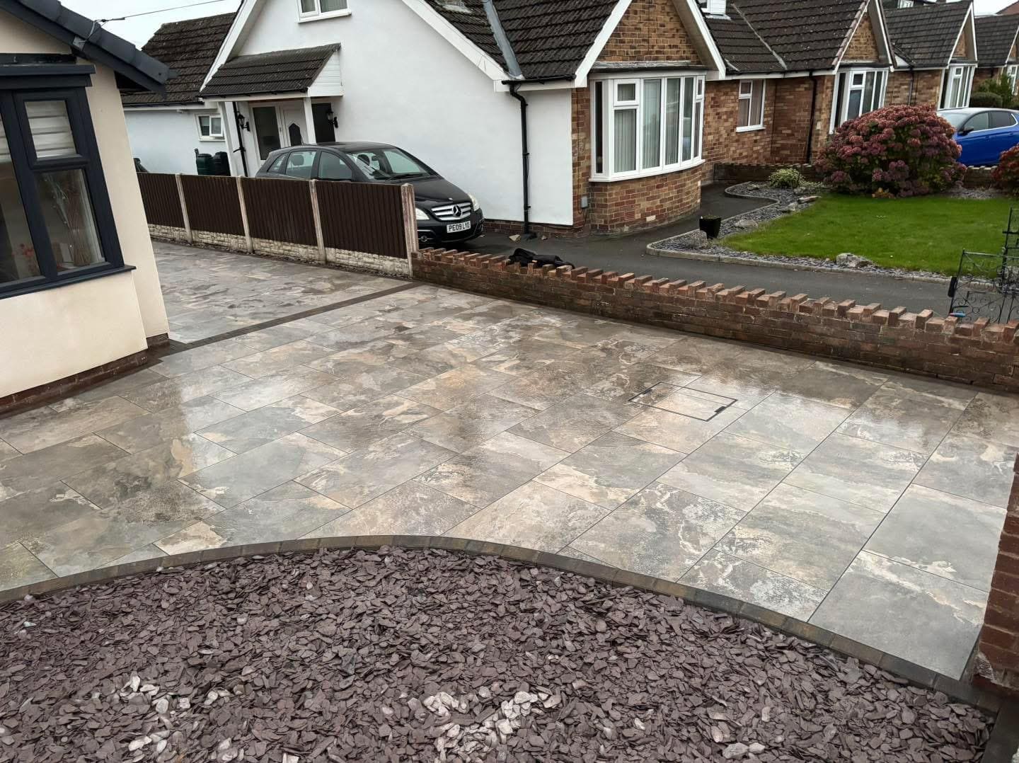 Porcelain patio installation with decorative slate border in Glasgow