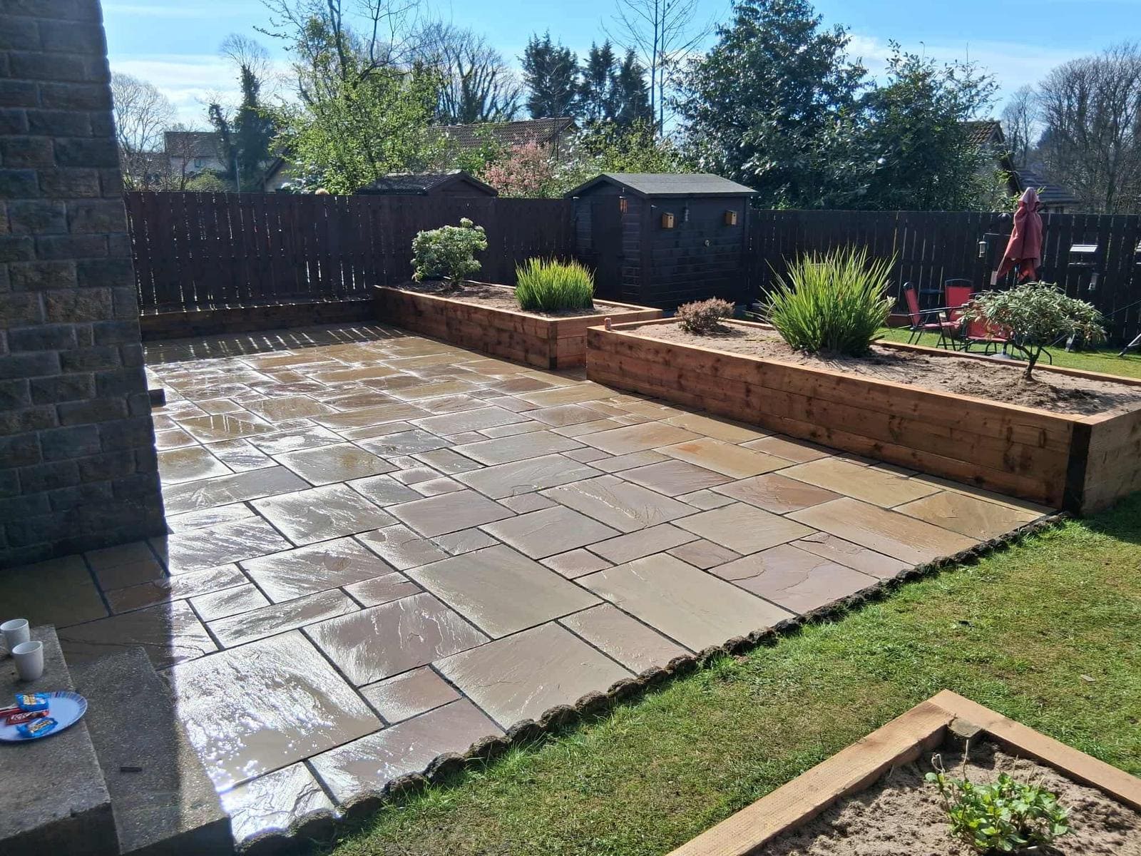 Natural sandstone patio with porcelain paving at Scottish home