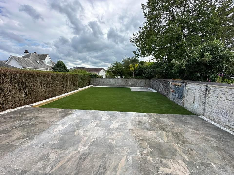 Completed garden with porcelain patio and fresh turf lawn installation
